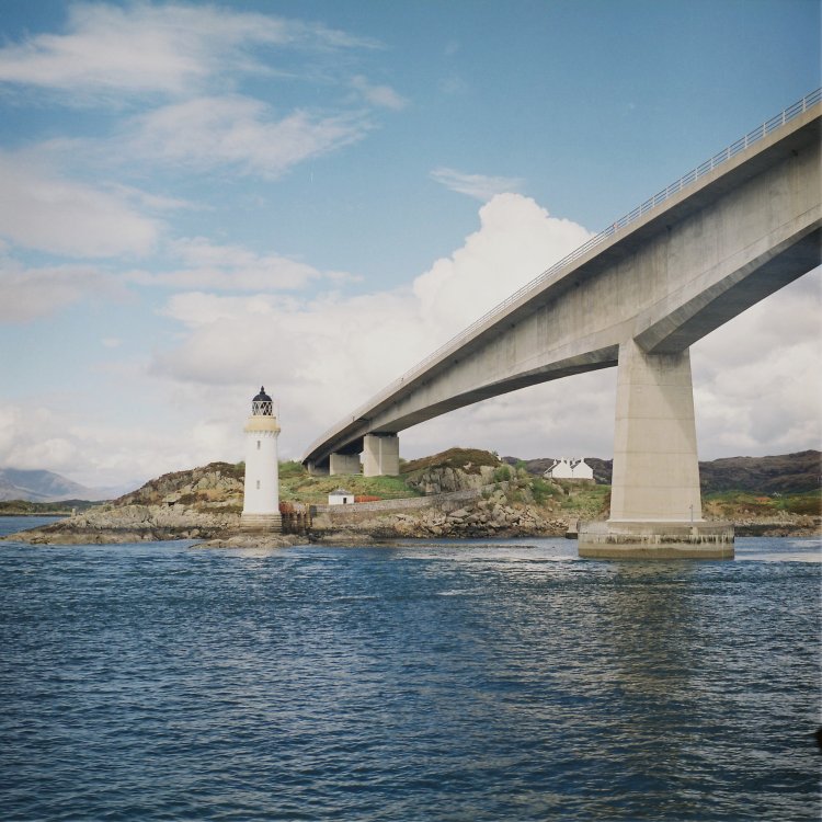 "lighthouse near bridge"